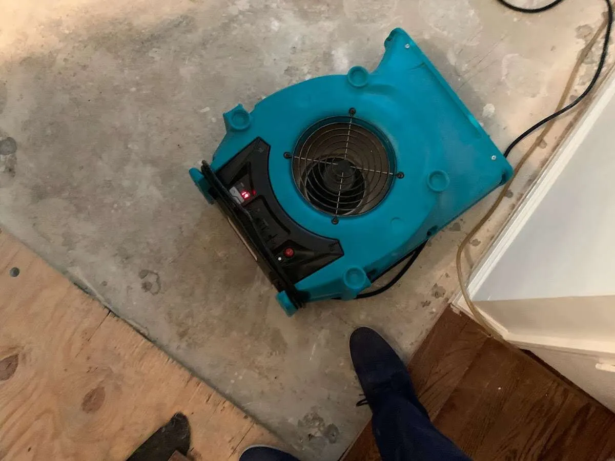 Air mover drying subfloor during Commercial Water Damage Restoration in Osage Beach